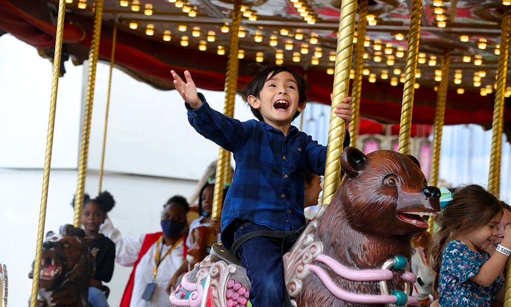 A Child Enjoying The Carousel At Hlsr Carnival Photo Courtesy Of Houston Livestock Show And Rodeo
