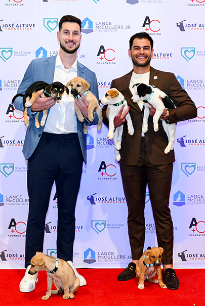 Kyle Tucker and Lance McCullers, Jr. with puppies (Photo by CatchLight Group)